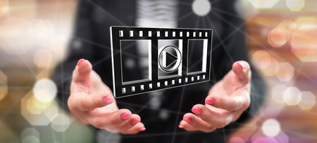Movies, video and cinema concept above the hands of a woman in backgroundの写真素材