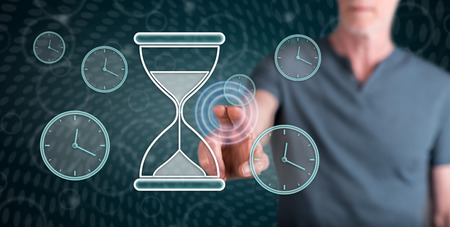 Man touching a time management concept on a touch screen with his finger