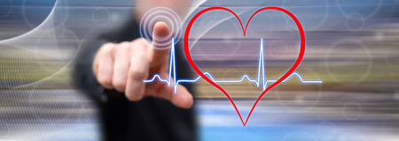 Man touching a heart beats graph on a touch screen with his finger