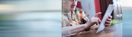 Old woman using tablet at home. panoramic banner