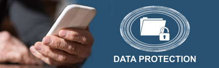 Hand holding mobil phone with data protection concept on backgroundの写真素材