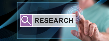 Man touching a research concept on a touch screen with his fingerの写真素材