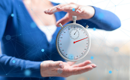 Time concept between hands of a woman in background