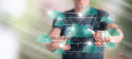 Man touching a cloud networking concept on a touch screen with his fingersの写真素材