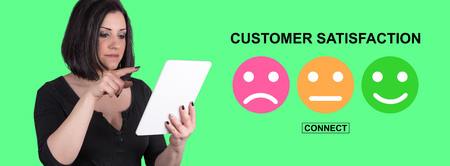 Woman using digital tablet with customer satisfaction concept on backgroundの写真素材