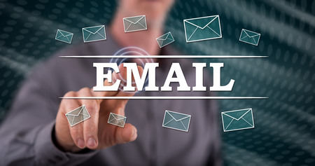 Man touching an e-mail concept on a touch screen with his fingerの写真素材