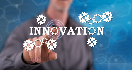 Man touching an innovation concept on a touch screen with his fingerの写真素材
