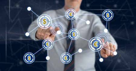 Man touching a financial network on a touch screen with his fingersの写真素材