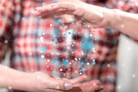 Global connection concept between hands of a woman in backgroundの写真素材