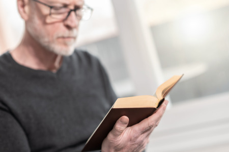 Man sitting and reading a bookの写真素材