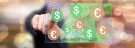 Man touching a currency exchange concept on a touch screen with his fingerの写真素材