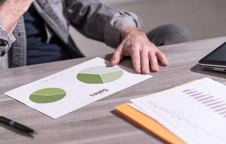 Businessman analyzing a sales pie chart