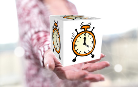 Time concept above the hand of a woman in backgroundの写真素材