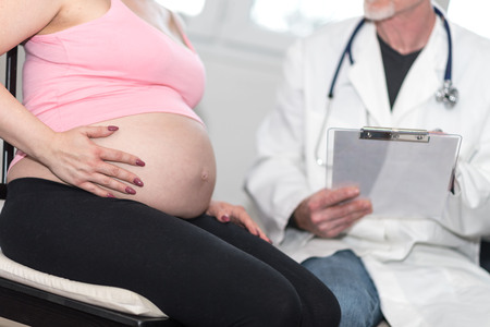 Pregnant woman with doctor during medical visit