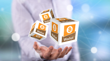 Bitcoin wallet concept above the hand of a man in background