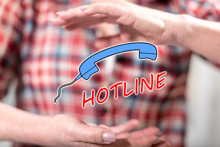 Hotline concept between hands of a woman in backgroundの写真素材