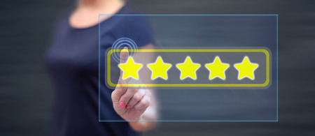 Woman touching a quality concept on a touch screen with her finger