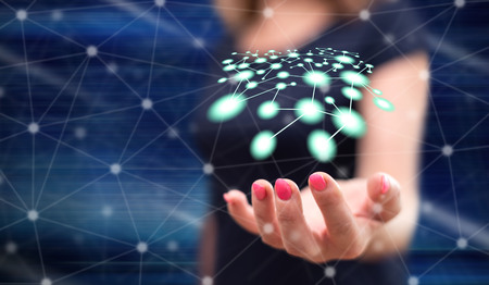 Network concept above the hand of a woman in backgroundの写真素材