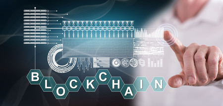 Man touching a blockchain concept on a touch screen with his fingerの写真素材
