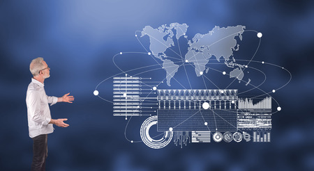 Businessman showing a global business digital interface concept on a wall screen