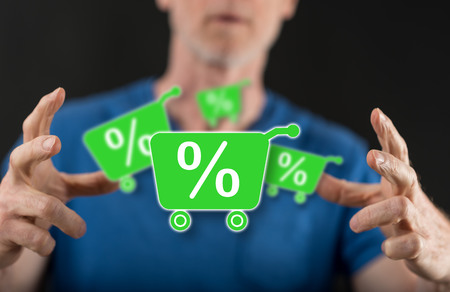 Percent discount concept between hands of a man in backgroundの写真素材