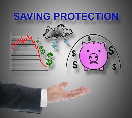 Saving protection concept levitating above a hand on grey backgroundの写真素材