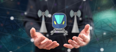 Smart train concept above the hands of a man in backgroundの写真素材