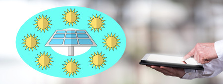 Man using a tablet with clean energy concept