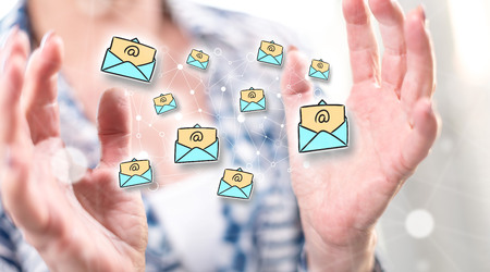 E-mail concept between hands of a woman in backgroundの写真素材