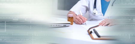 Female doctor writing prescription in medical office. panoramic bannerの写真素材