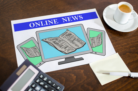 Online news concept on a paper placed on a deskの写真素材