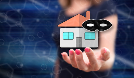 Home burglary concept above the hand of a woman in backgroundの写真素材