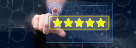 Man touching a quality concept on a touch screen with his finger