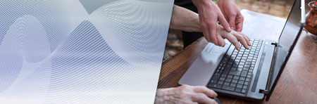 Old woman learning to use a laptop. panoramic banner