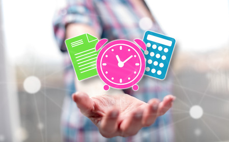 Tax time concept above the hand of a woman in backgroundの写真素材