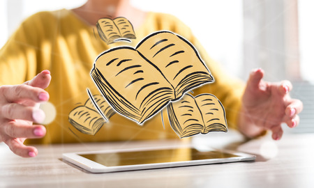 Digital tablet with education concept between hands of a woman in backgroundの写真素材