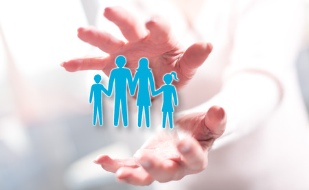 Family concept between hands of a woman in backgroundの写真素材