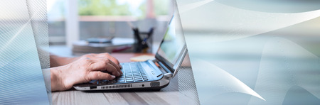 Female hands using a laptop in office. panoramic banner