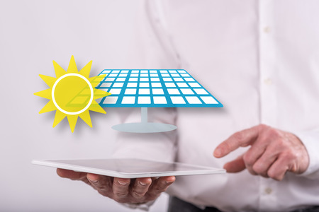 Eco energy concept above a tablet held by a man in backgroundの写真素材