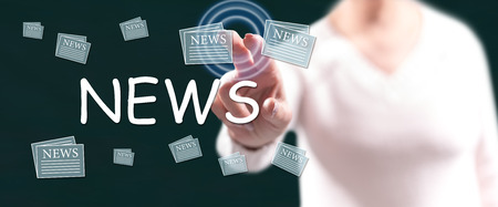 Woman touching a news concept on a touch screen with her fingersの写真素材