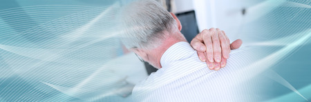 Businessman suffering from neck pain at office. panoramic bannerの写真素材