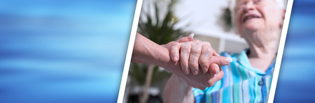 Hands of young woman holding the hands of an old woman. panoramic bannerの写真素材