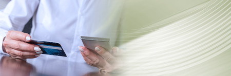 Woman using smartphone and credit card for online payment. panoramic banner