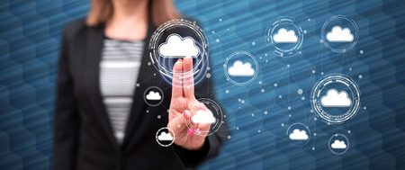 Woman touching a cloud networking concept on a touch screen with her fingersの写真素材