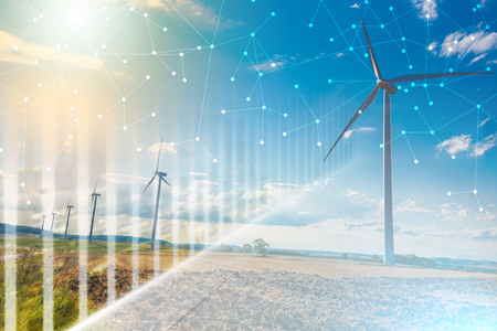 Wind turbines in a rural landscape on sky background with light effect and network