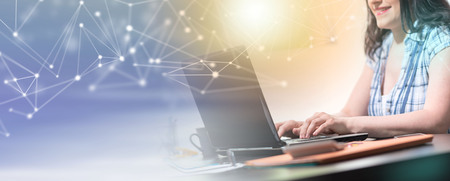 Young attractive businesswoman working on laptop at office, light effect. multiple exposure