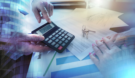 Real estate agent showing the purchase price on a calculator to his client; multiple exposureの写真素材