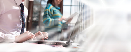 Businessman working on laptop in office. multiple exposure