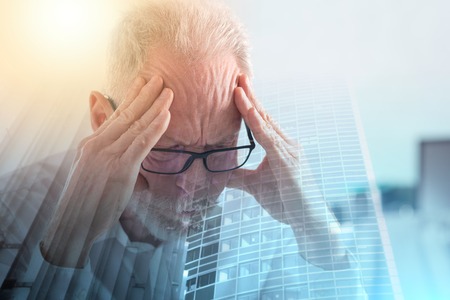 Portrait of a tired senior businessman; multiple exposureの写真素材