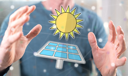 Eco energy concept between hands of a man in background